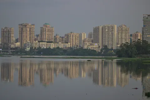 Apartment towers reflected in the still water of Powai Lake