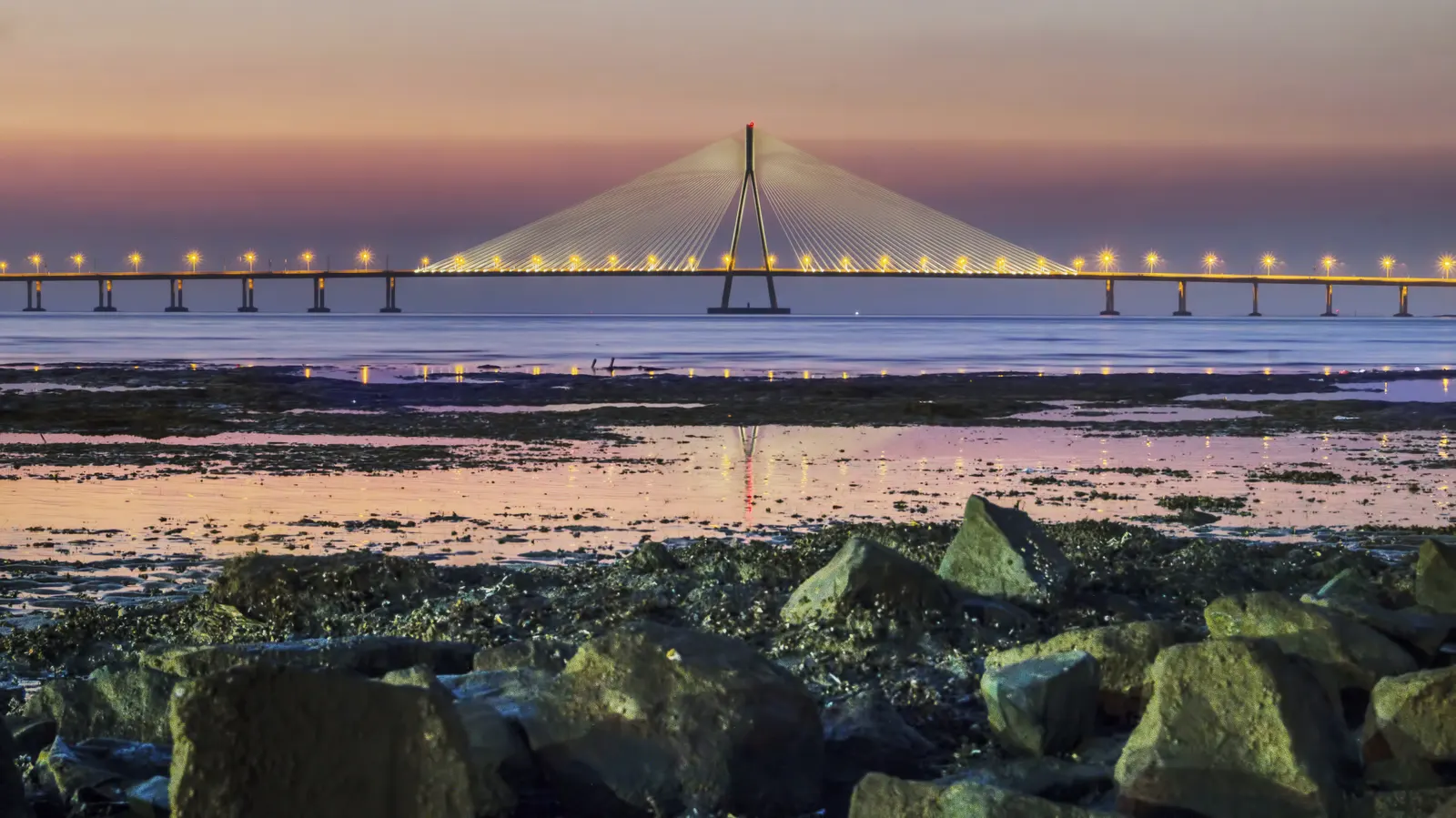 The Sea Link beyond the rocky Mumbai shoreline