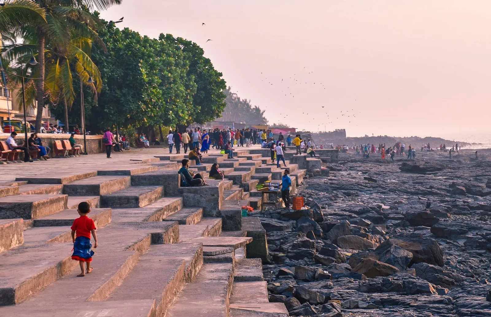 Wide stone steps of the Bandstand promenade leading down to the rocks in evening light