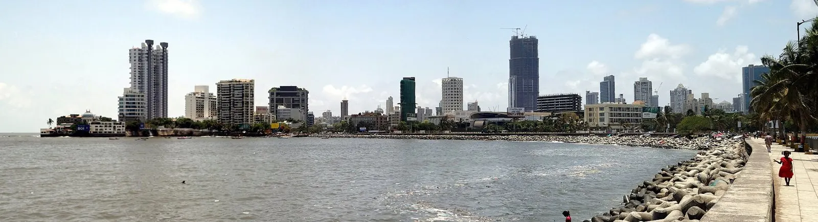 Worli seawall promenade curving along the water towards the city skyline