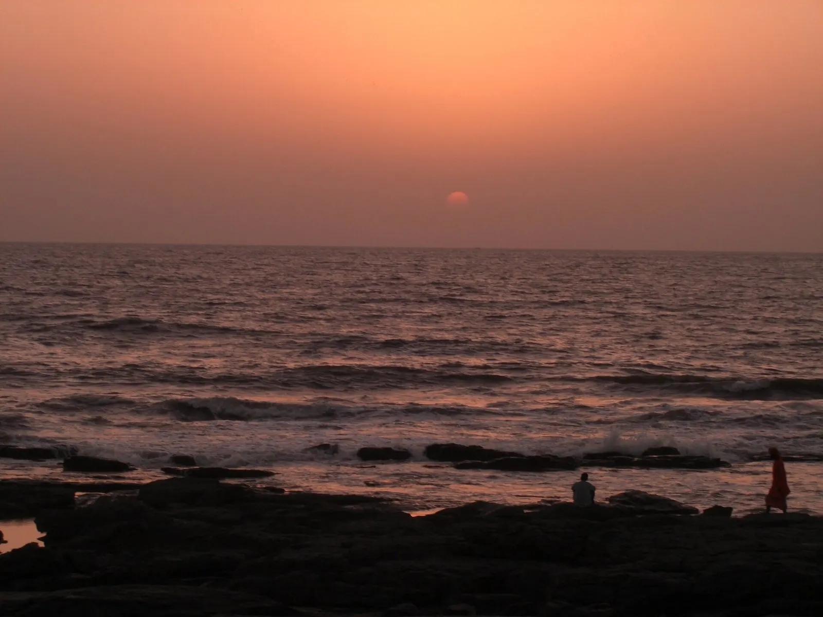 Sun setting over the Arabian Sea from the rocks at Worli Sea Face