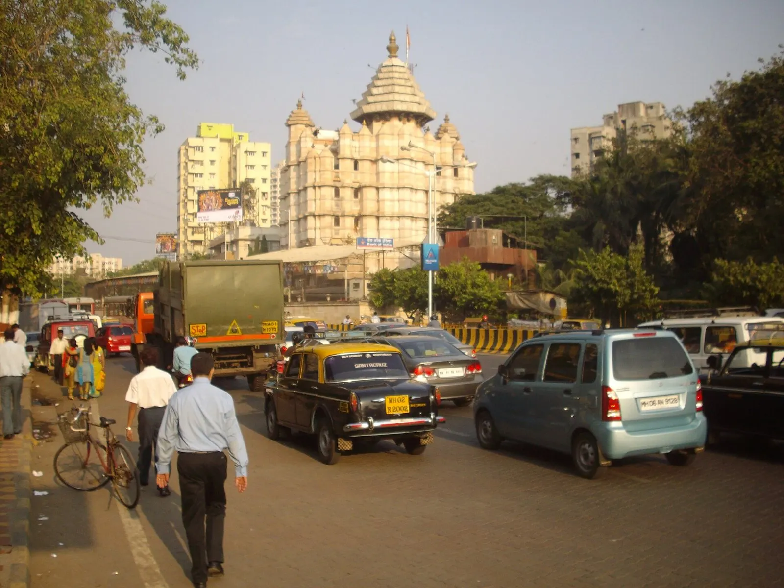 Siddhivinayak Temple rising above traffic and taxis on a Prabhadevi street