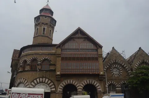 Crawford Market’s clock tower and gabled stone façade under a grey sky