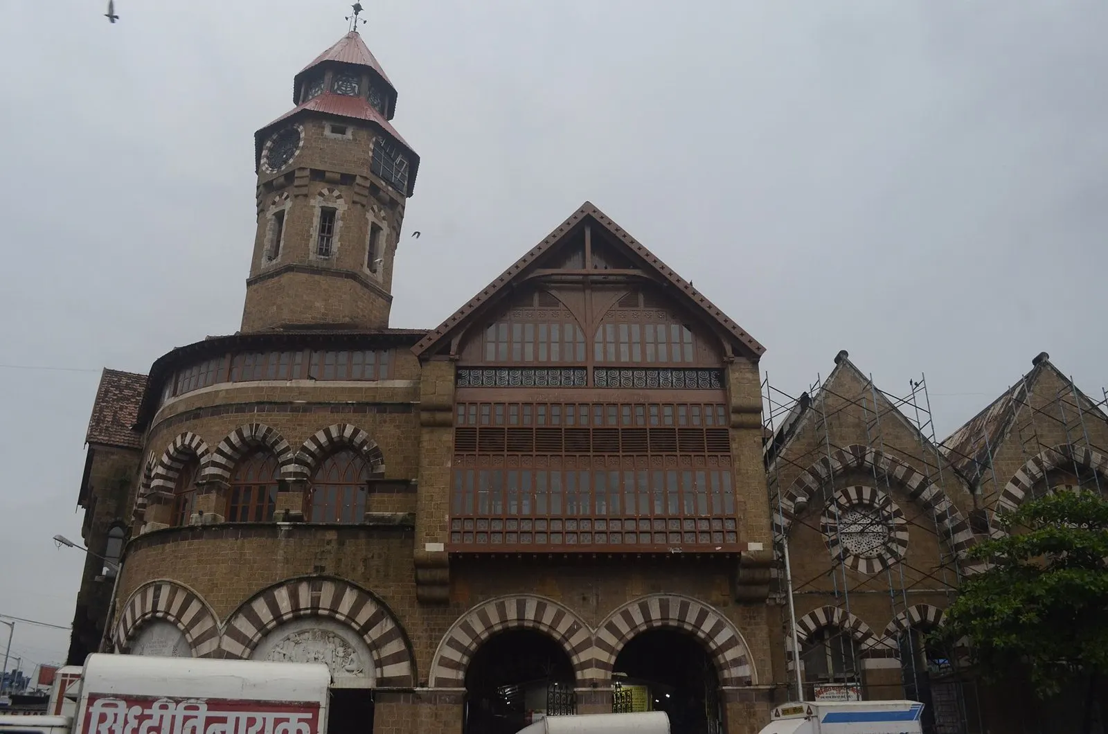 Crawford Market’s clock tower and gabled stone façade under a grey sky