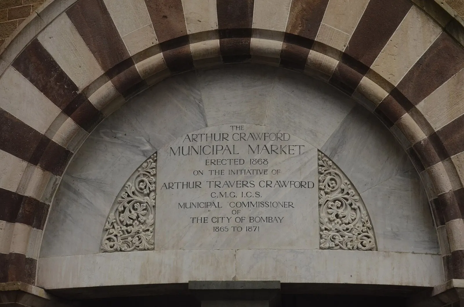 Marble inscription naming the Arthur Crawford Municipal Market within a striped arch